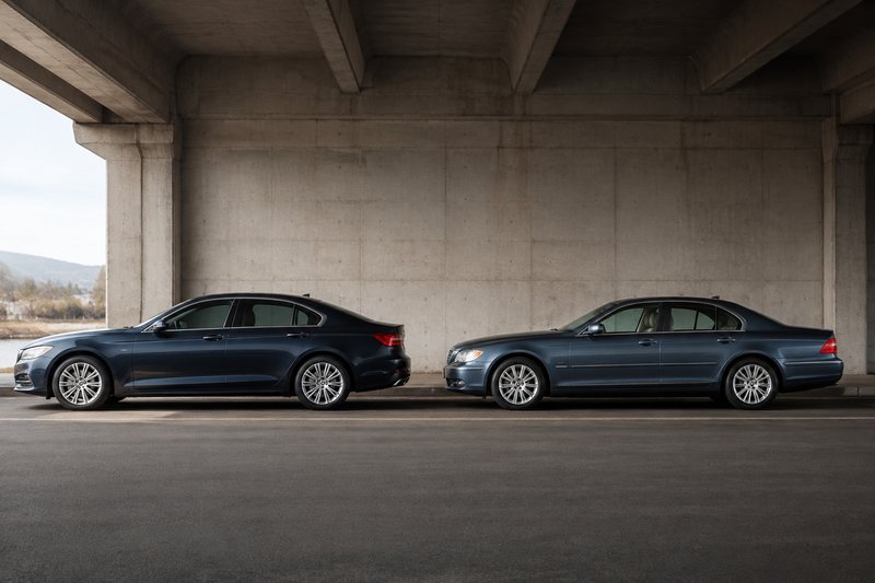 Two generations of unbranded premium sedans parked side by side